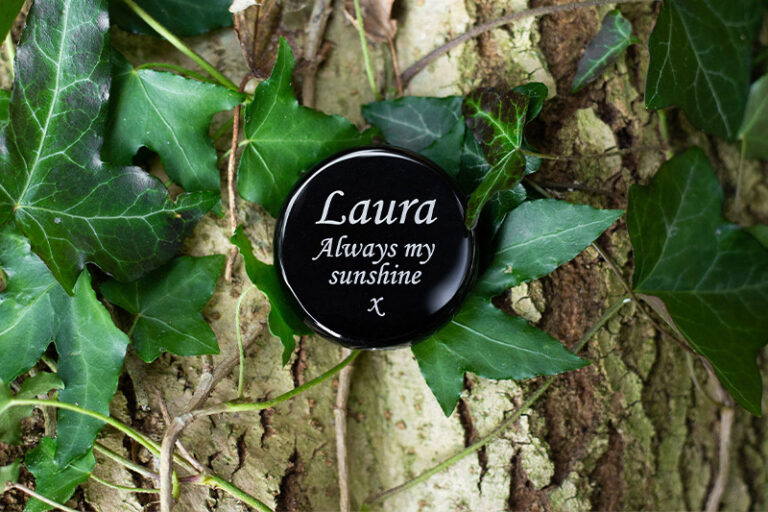 Agate stone in black with text in white. Text consists of "Laura. Always my sunshine x"