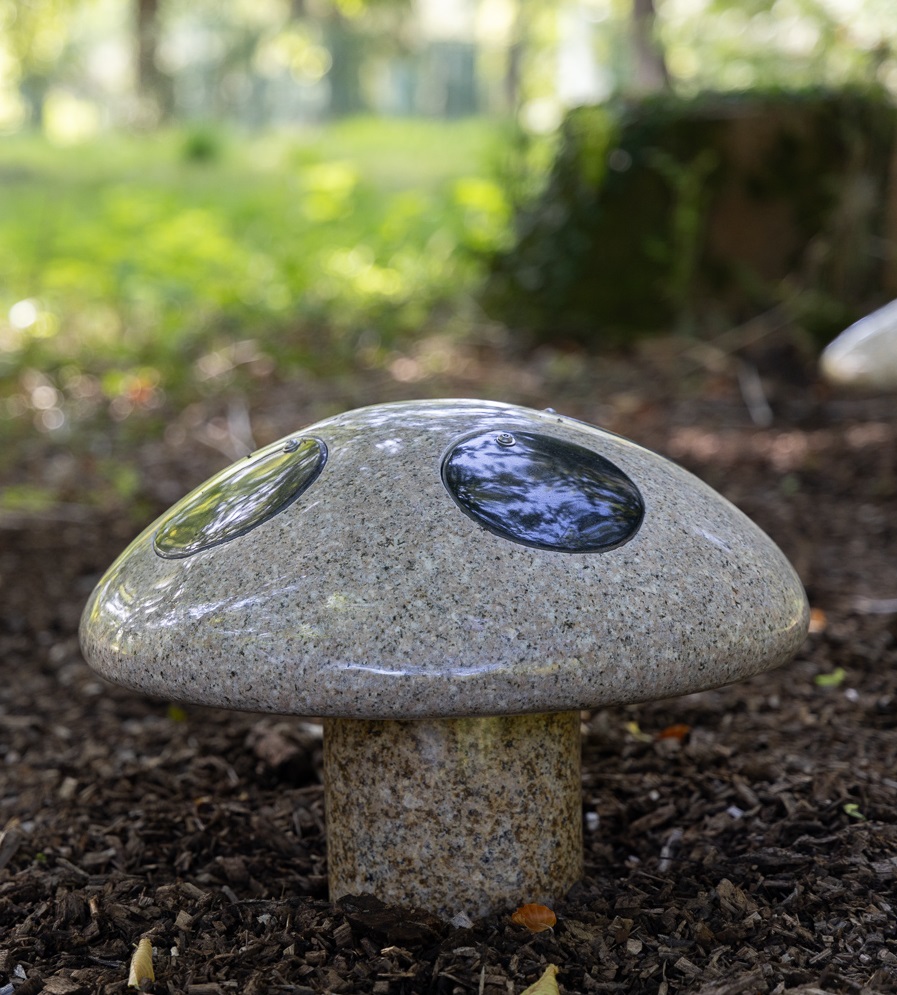 Decorative, granite mushrooms on the grounds of Chiltern crematorium memorial garden.