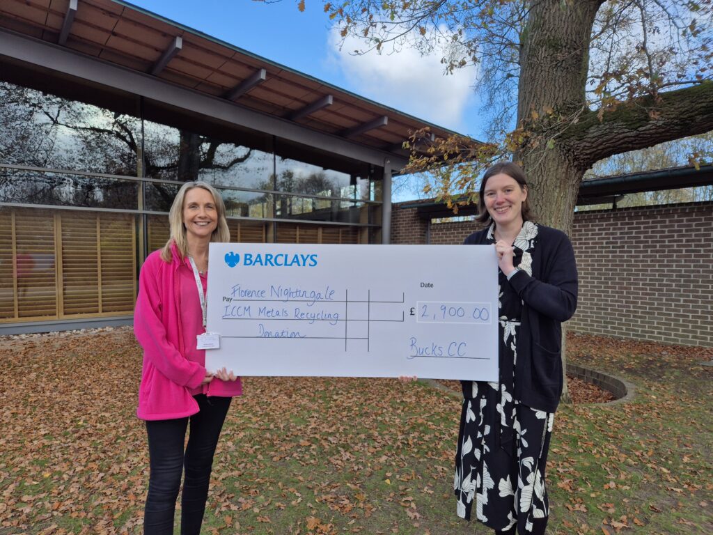 Crematorium workers hold a cheque donation